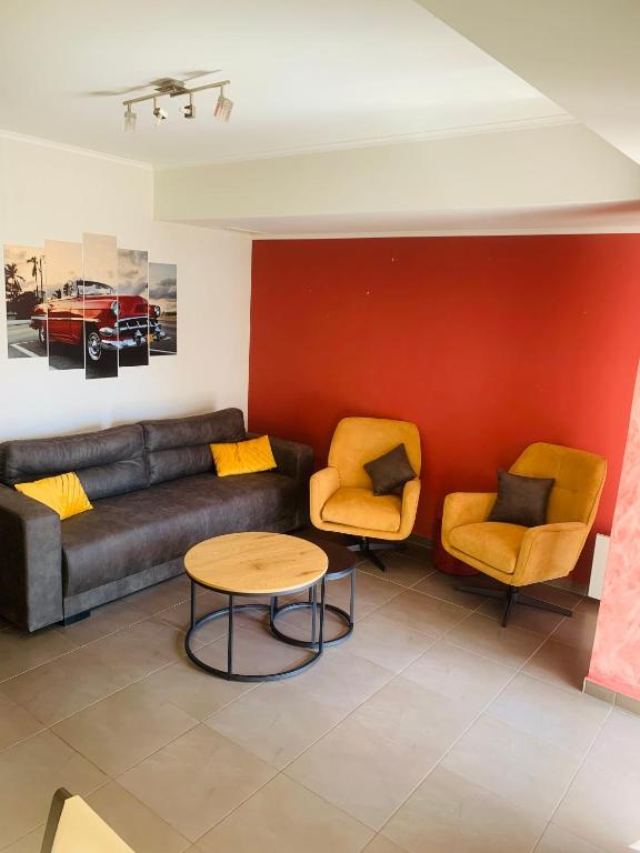 a living room with a couch and two chairs at Smile Stay Apartment in Alexandroupoli