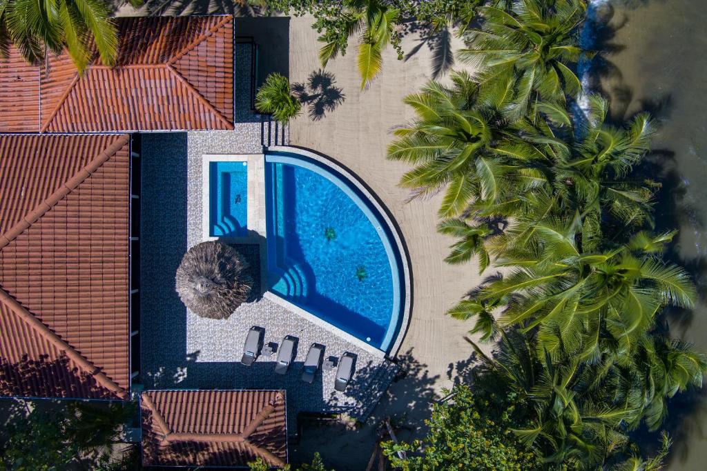 an overhead view of a swimming pool next to a house at 6-Guest Beachfront Oasis w Private Pool in Maya Beach