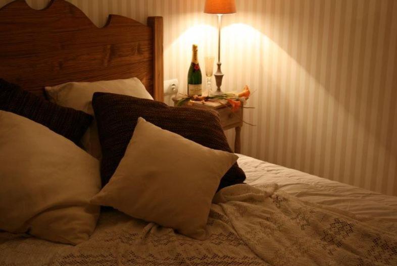 Postel nebo postele na pokoji v ubytování Apartamentos Alcoba de Baco