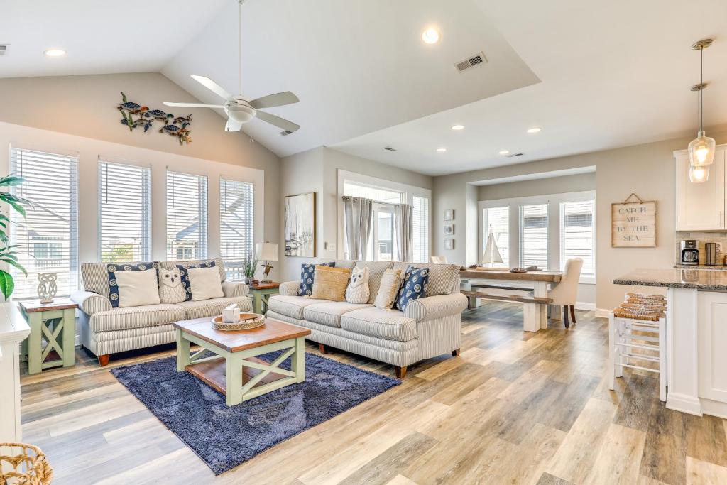 a living room with a couch and a table at Surf City House about 400 Ft Walk to Beach with Decks! in Surf City
