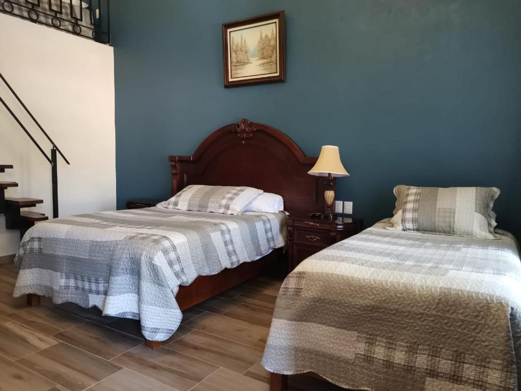 Postel nebo postele na pokoji v ubytování Mirador Johya Hotel