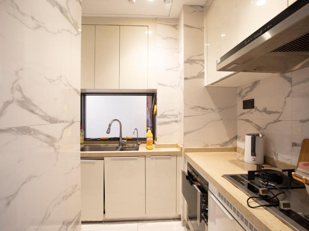 Kuchyň nebo kuchyňský kout v ubytování Yiweidu Youth Apartment