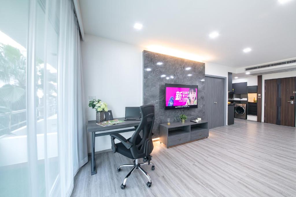 an office with a desk and a monitor on a wall at Civic Park in Bangkok