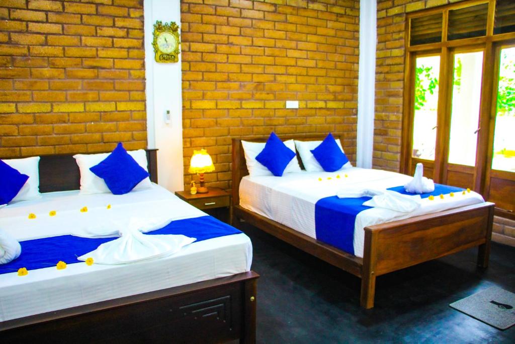Postel nebo postele na pokoji v ubytování Sigiriya Dream Inn