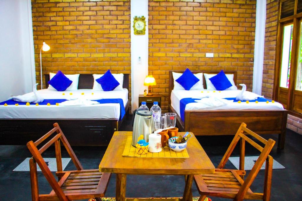 Postel nebo postele na pokoji v ubytování Sigiriya Dream Inn