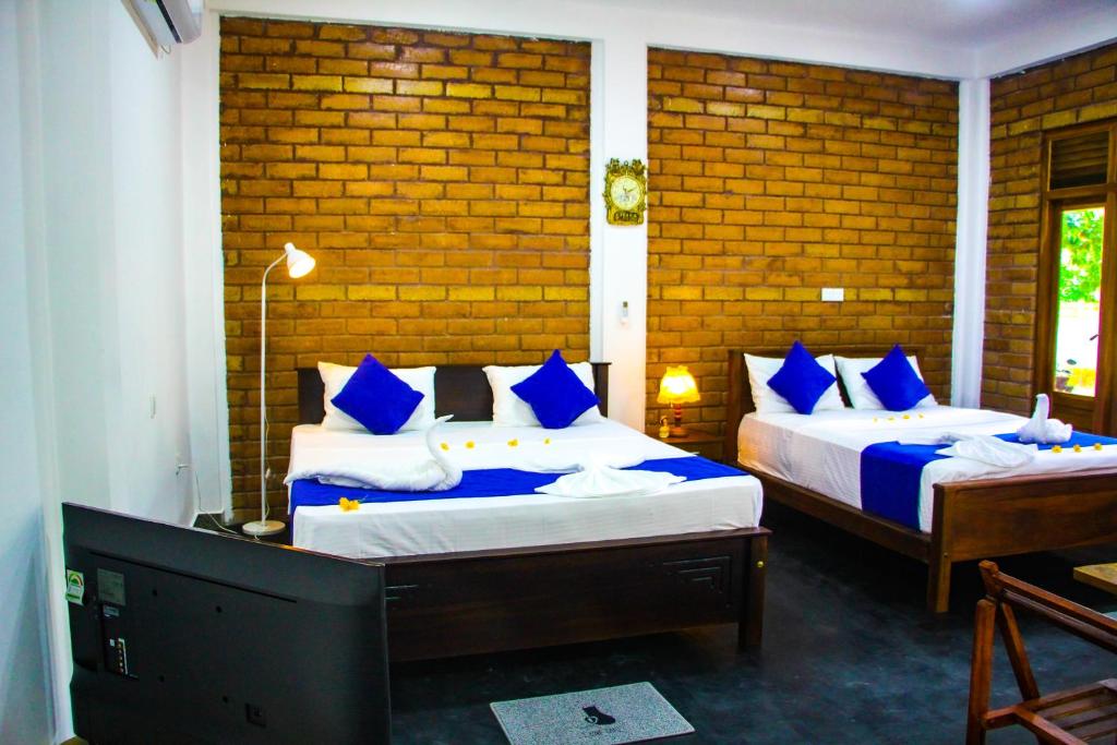 Postel nebo postele na pokoji v ubytování Sigiriya Dream Inn