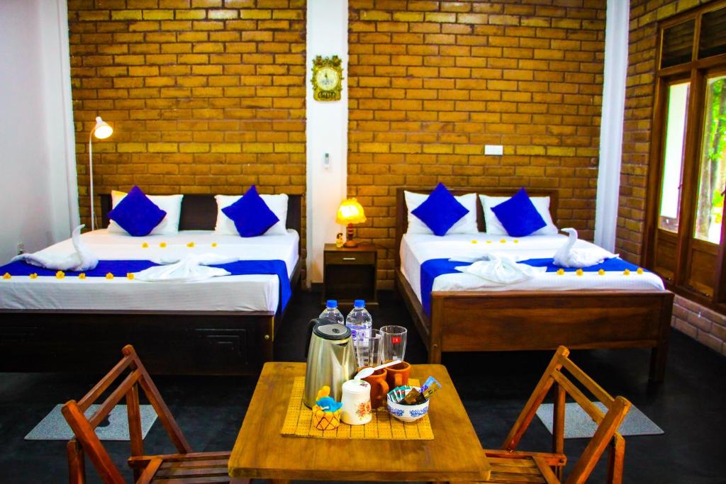 Postel nebo postele na pokoji v ubytování Sigiriya Dream Inn