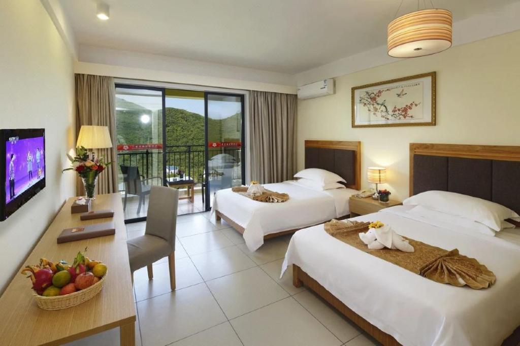 Postel nebo postele na pokoji v ubytování Dadonghai Ruiya resort hotel