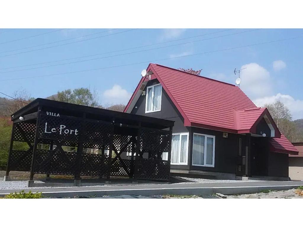 a black and red building with a red roof at Villa Le Port - Vacation STAY 61630v in Abuta