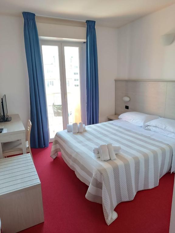 Postel nebo postele na pokoji v ubytování Hotel Berenice