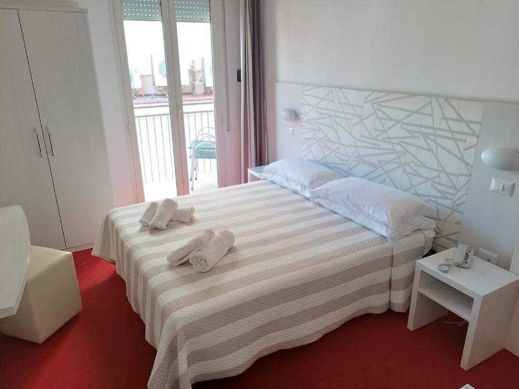 Postel nebo postele na pokoji v ubytování Hotel Berenice