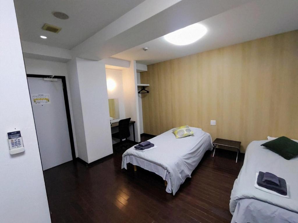 Postel nebo postele na pokoji v ubytování Hotel Chuo Oasis