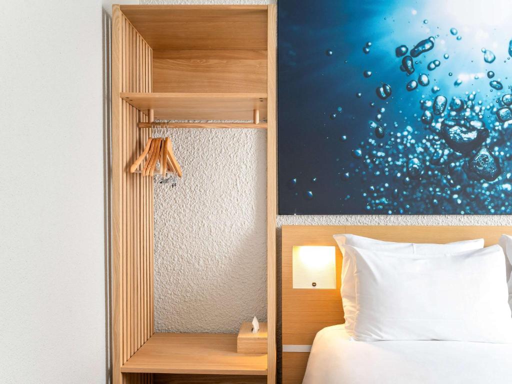 Postel nebo postele na pokoji v ubytování Novotel Grenoble Nord Voreppe
