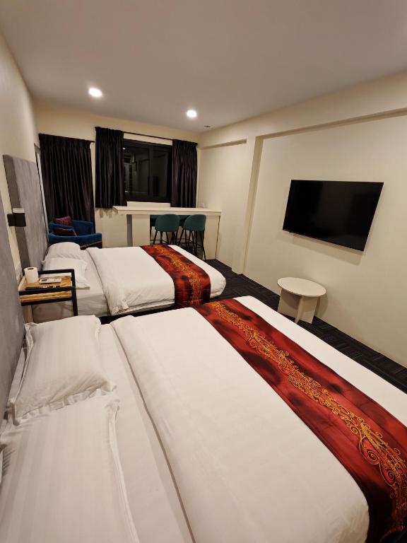 Postel nebo postele na pokoji v ubytování Pangkor Pop Ash Hotel