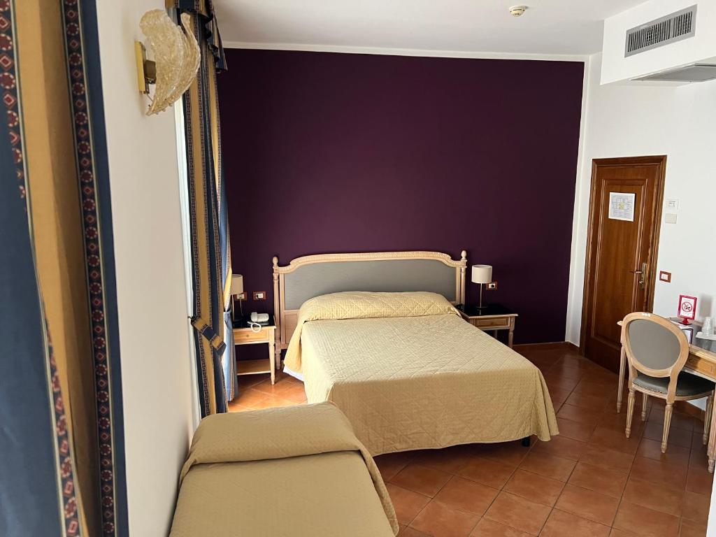 Posteľ alebo postele v izbe v ubytovaní Hotel Bologna