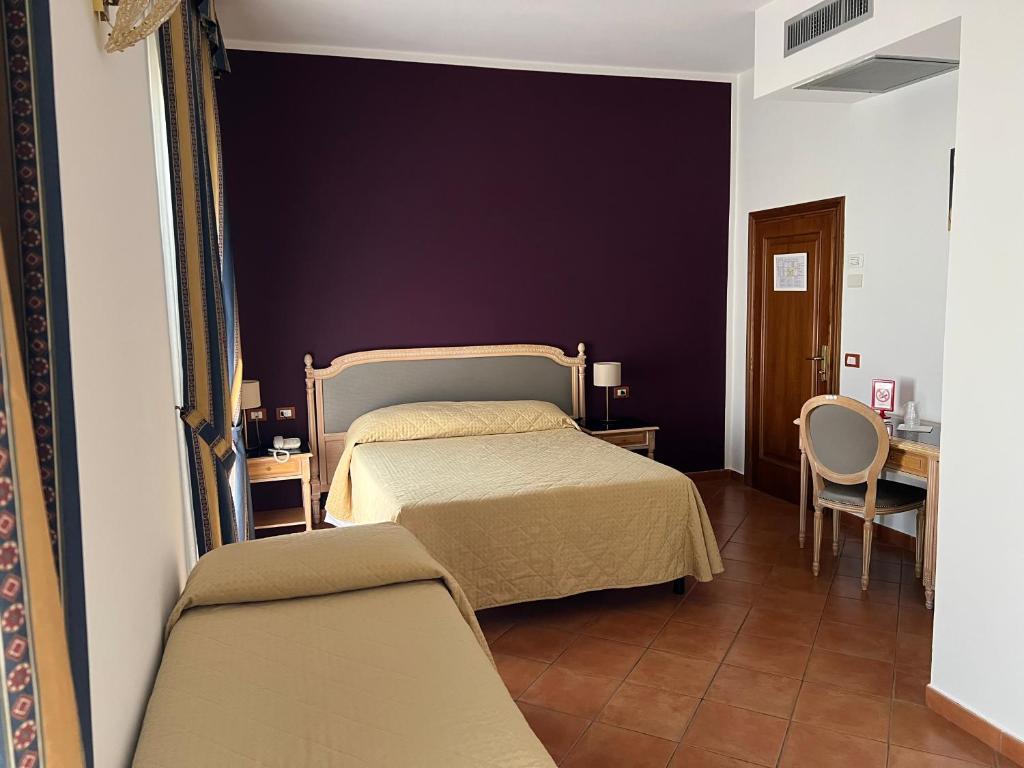 Posteľ alebo postele v izbe v ubytovaní Hotel Bologna