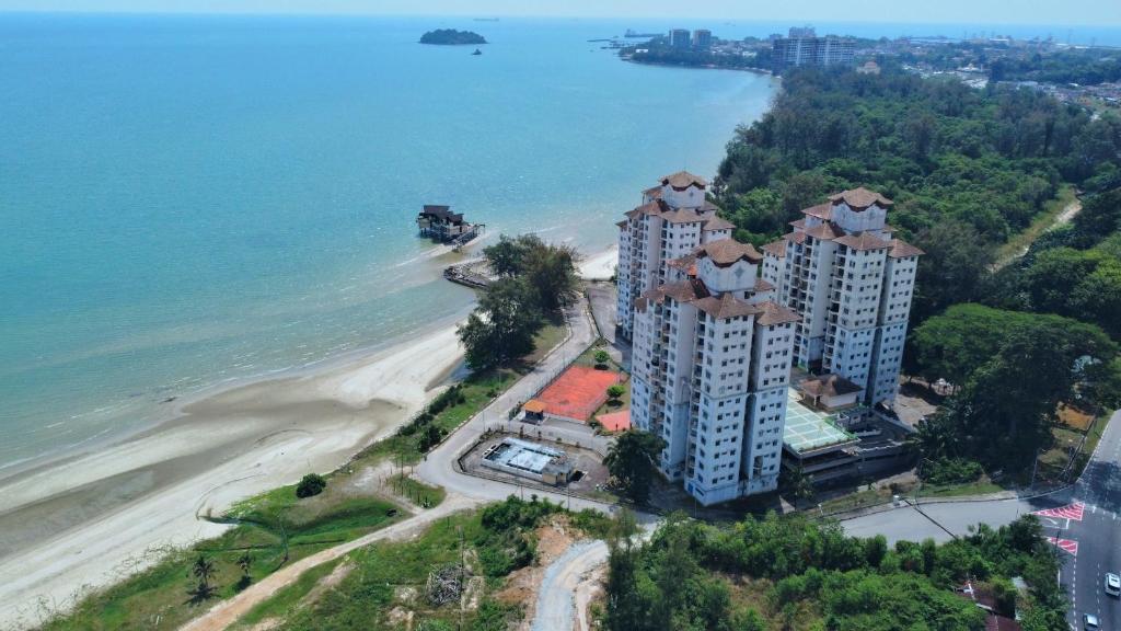 an aerial view of a building next to a beach at 2-5pax Sunshine BeachFront, Wifi, 50"TV, FREE PARKING & POOL in Port Dickson
