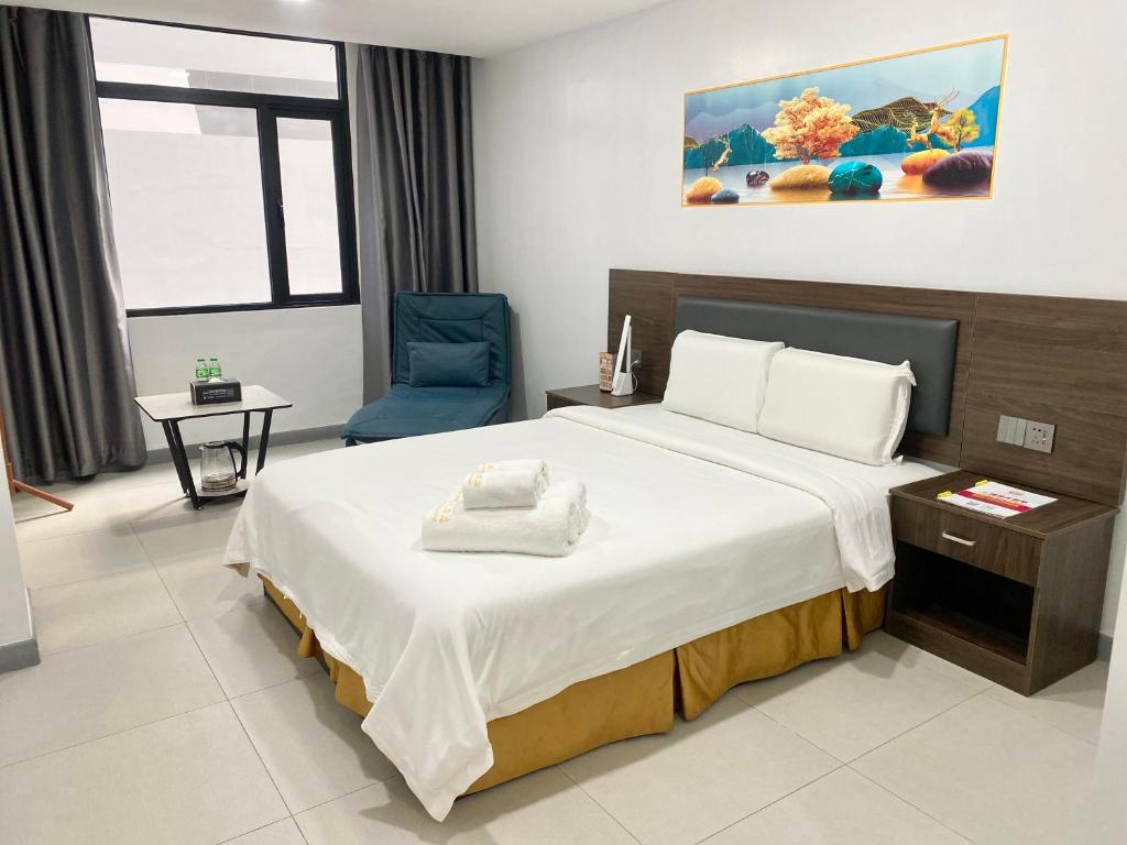 Postel nebo postele na pokoji v ubytování 广东大酒店Guangdon Business Hotel-SM Mall of Asia, SMX & Manila World Trade Center
