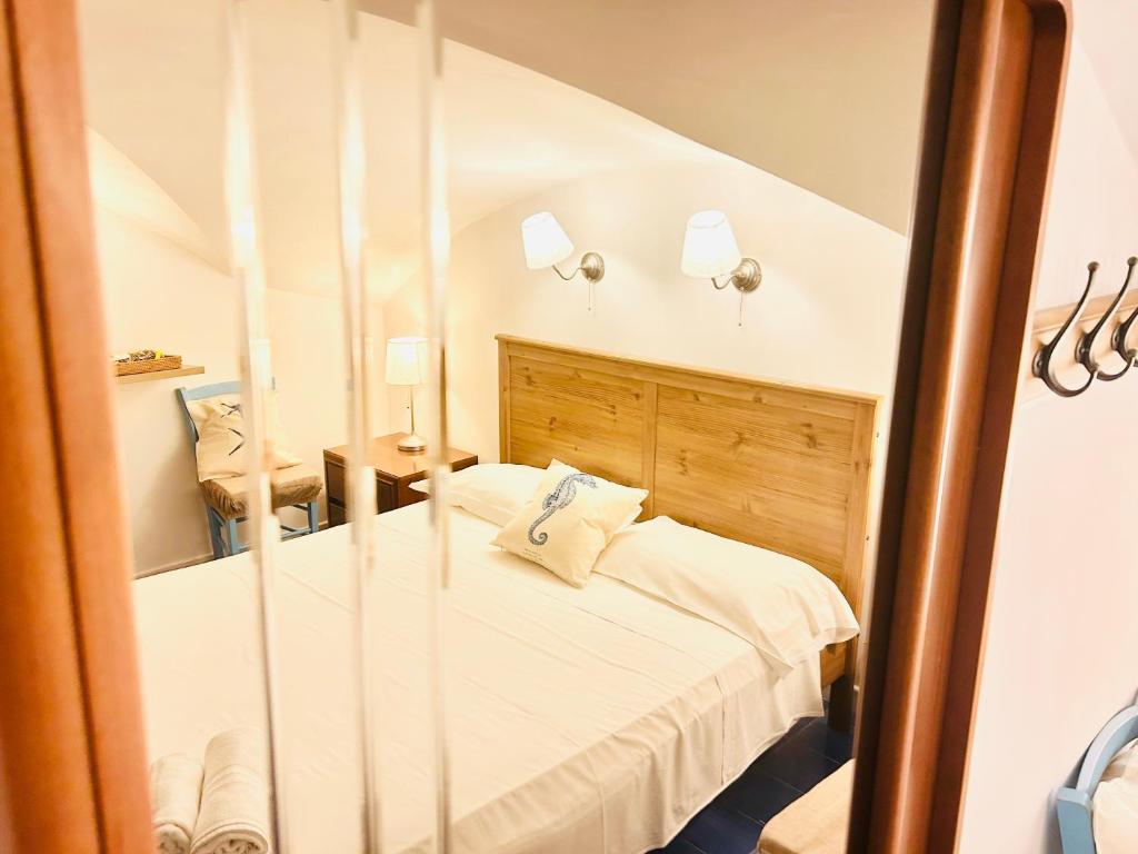a bedroom with a bed and a mirror at Acqua Marina - UN LETTO IDEALE in Gaeta