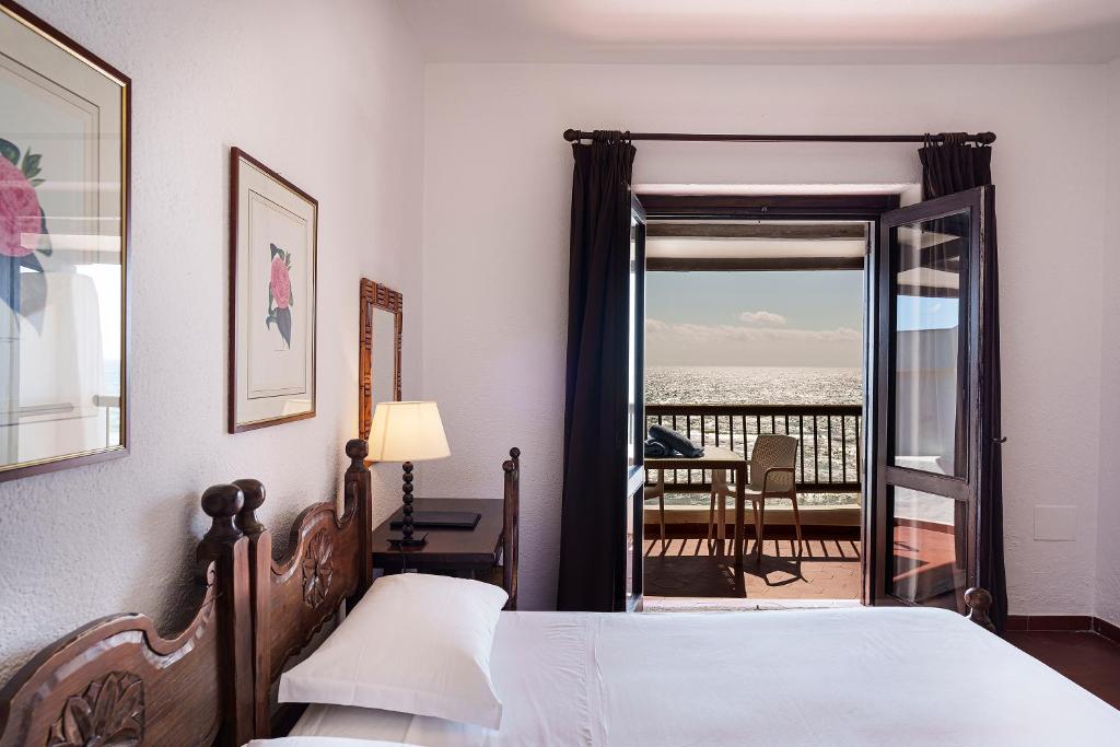 Postel nebo postele na pokoji v ubytování Hotel Le Dune