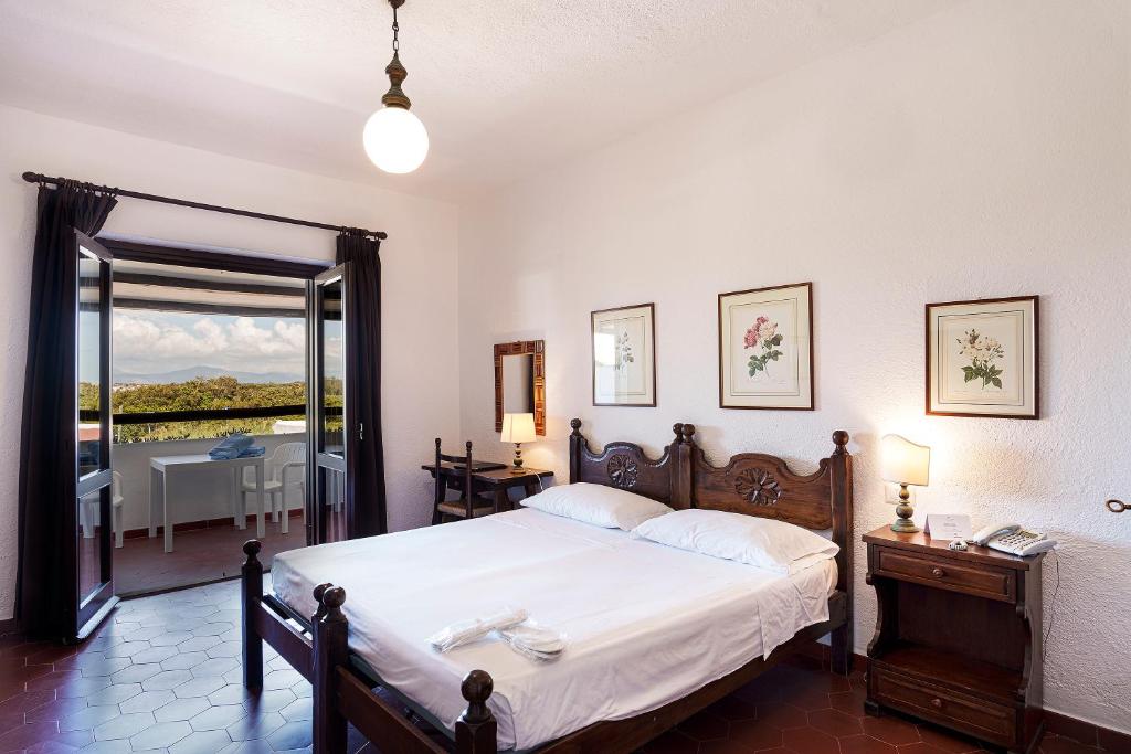 Postel nebo postele na pokoji v ubytování Hotel Le Dune