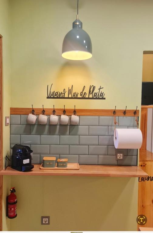 a shelf with a sign on the wall of a kitchen at Vinaros Mar de Plata in Vinarós