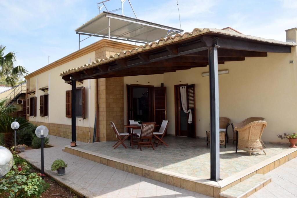 a pavilion with a table and chairs on a patio at Sara Relax Home in Mazara del Vallo
