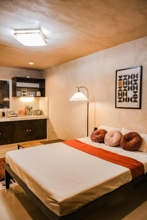 a bedroom with a large bed with pillows on it at DMall Central Stn 2 Near Beach in Boracay