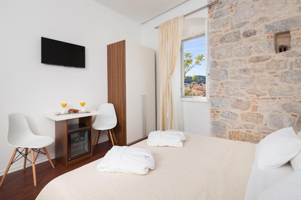 Posteľ alebo postele v izbe v ubytovaní Rooms Supreme Spalato