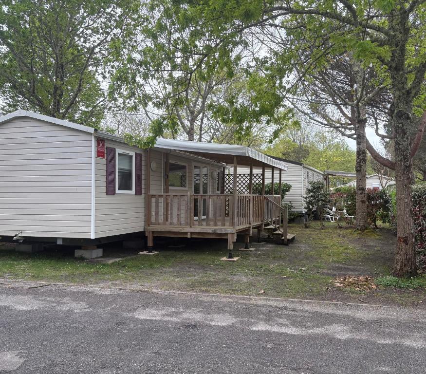 a mobile home with a porch and a deck at Mobilhome 642 3 chambres Siblu La Réserve in Gastes