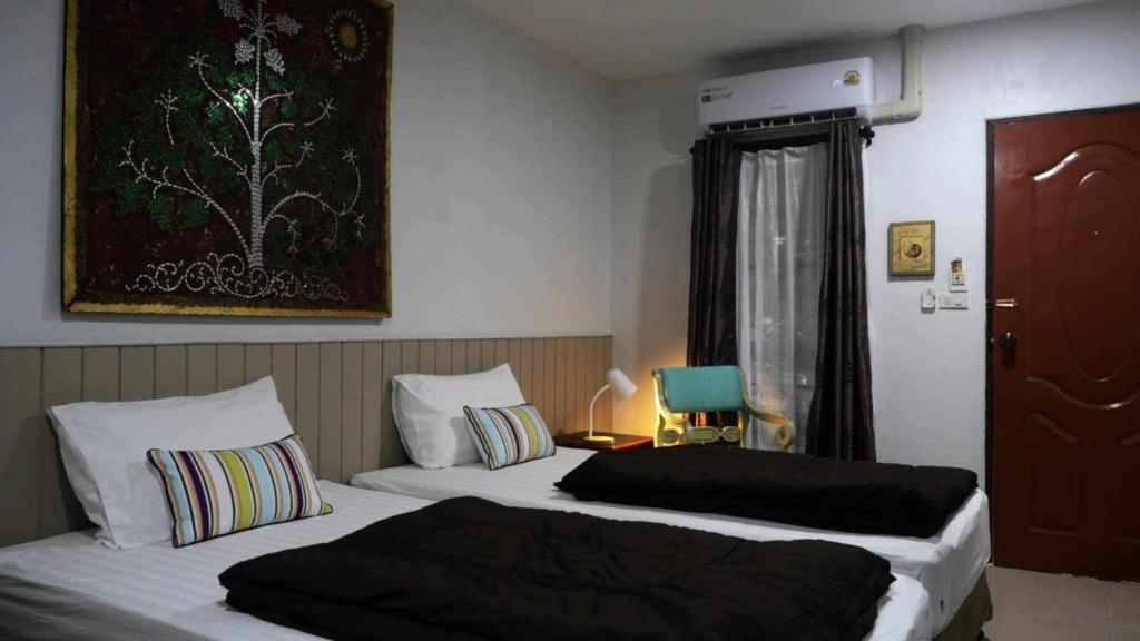 Postel nebo postele na pokoji v ubytování Koko Palm Inn