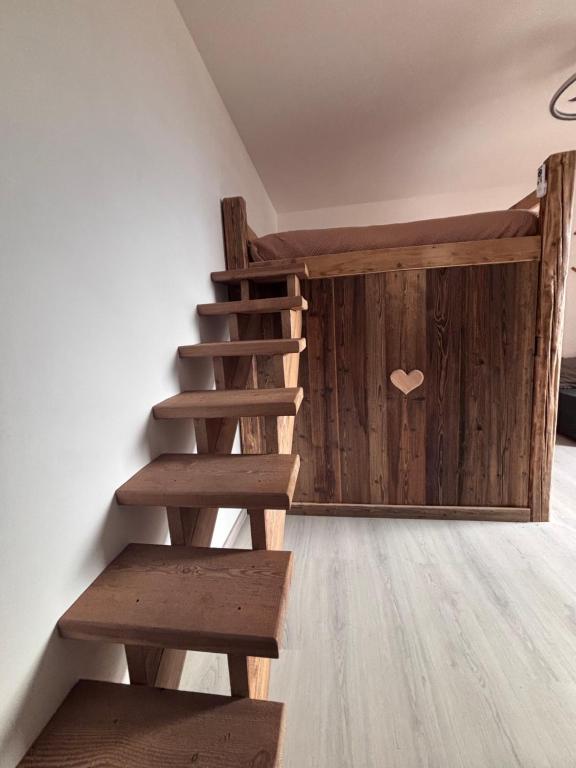a wooden staircase in a room with a wooden wall at Valley View Studio in Saint Vincent