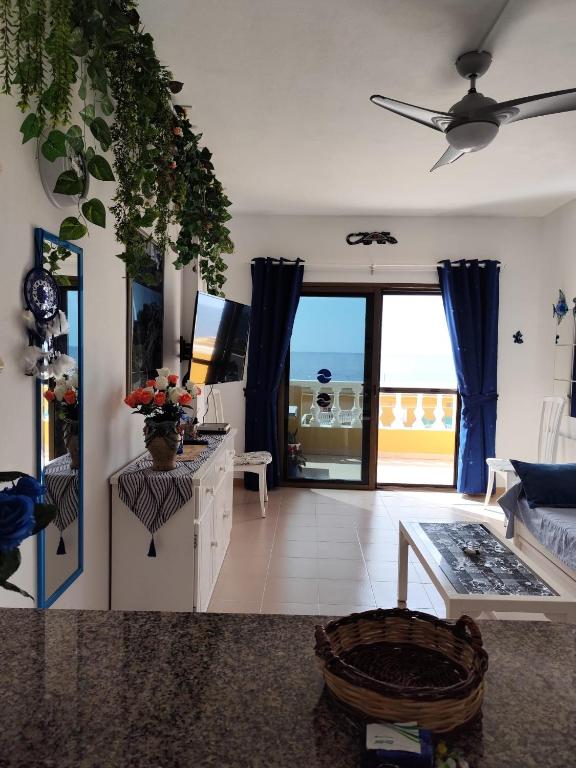 a living room with a view of the ocean at Arenas Blancas 203 in La Restinga