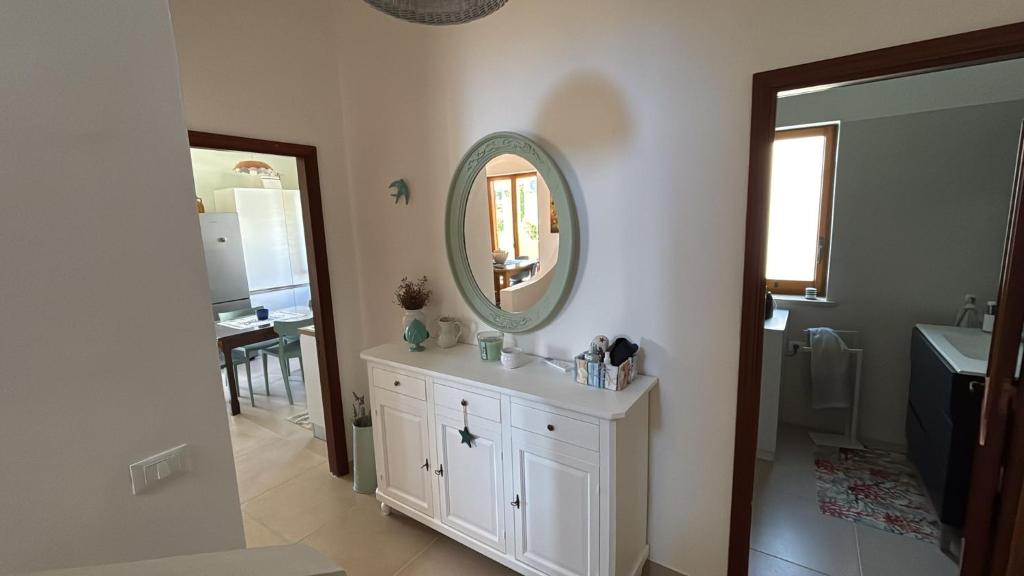 a bathroom with a sink and a mirror on the wall at Villa Ingrosso in Leporano Marina