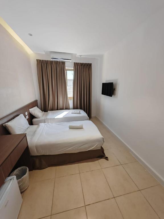 Postel nebo postele na pokoji v ubytování New Metropole Hotel - Jerusalem