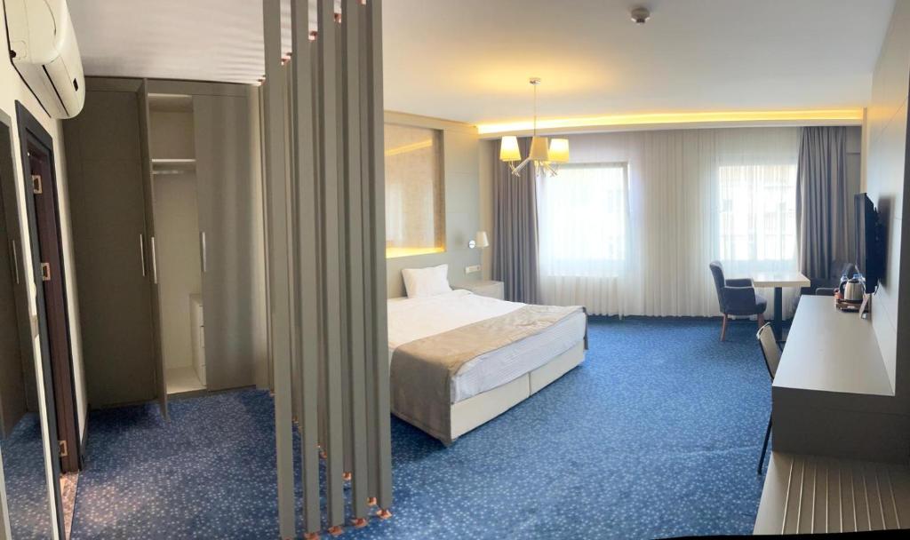 a hotel room with a bed and a table at Acar Suite Hotel in Istanbul