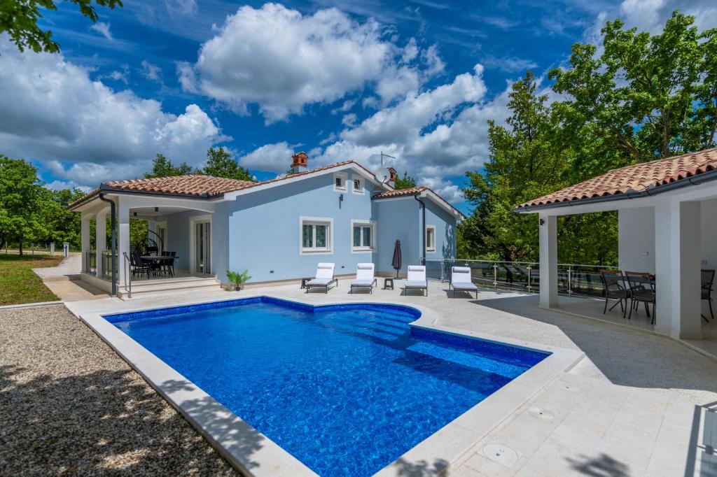 a villa with a swimming pool and a house at Villa ForRest, a charming villa surrounded by beautiful nature in Križanici
