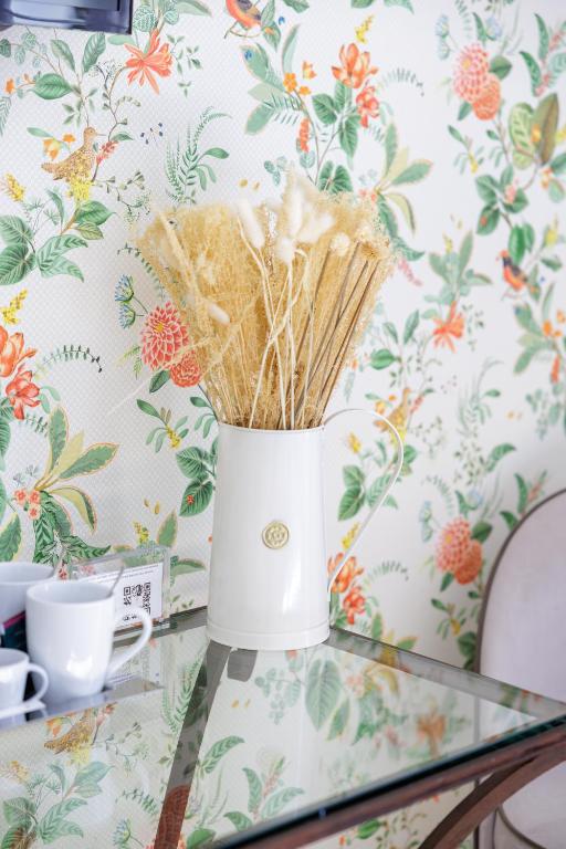 a vase on a table with straws at Hôtel La Villa Sainte Valérie Adults Only in Juan-les-Pins