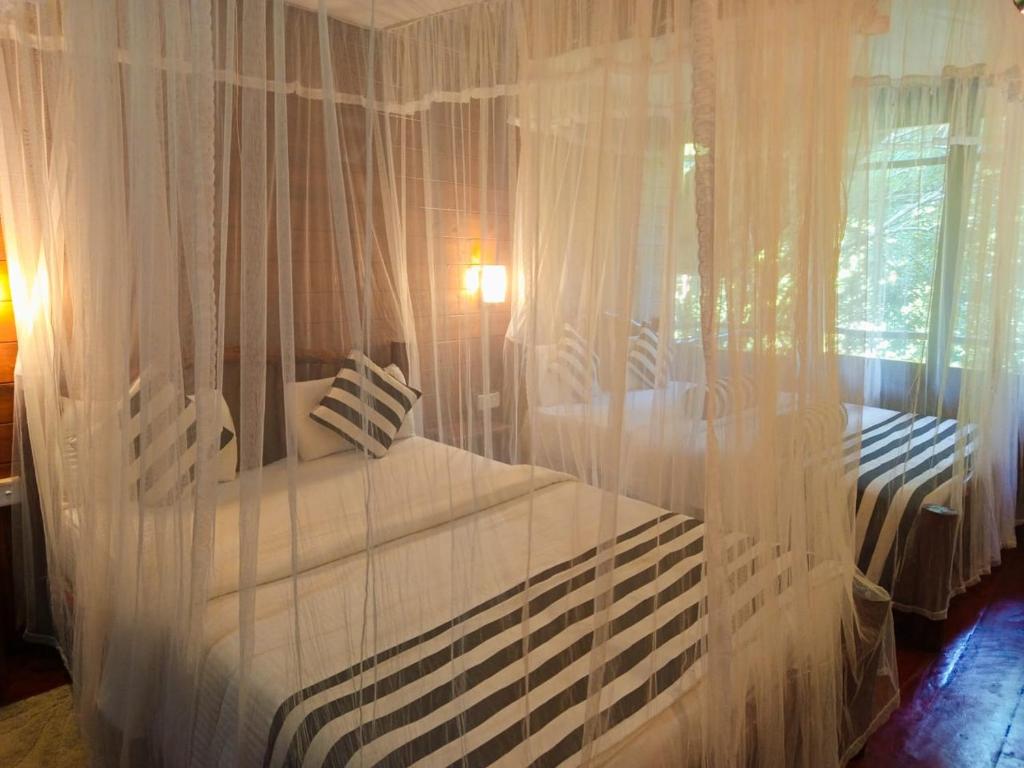 Postel nebo postele na pokoji v ubytování Eco Village