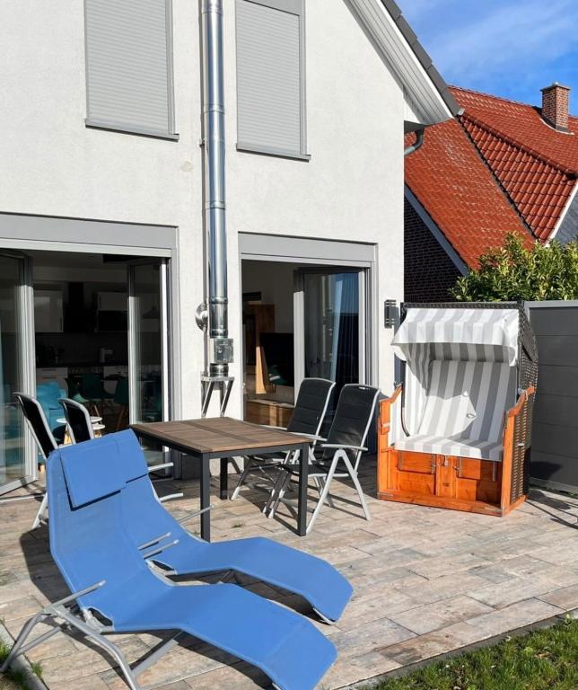 a patio with a wooden table and chairs at The Fehmarn Lodges - EMOTION - in Fehmarn