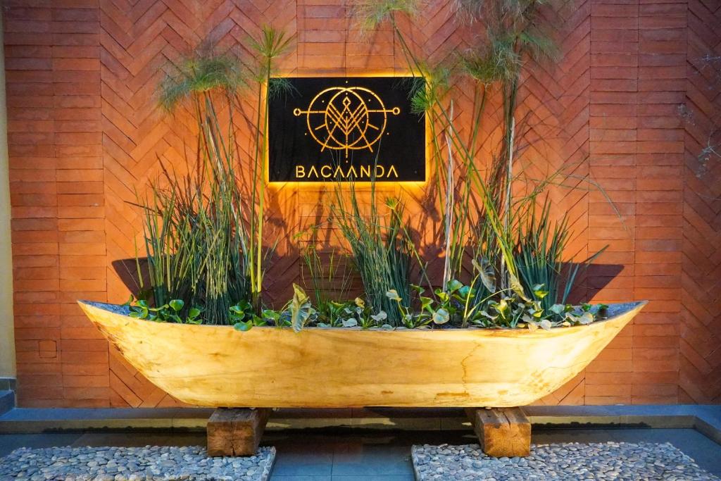 a wooden boat with a sign on a brick wall at Bacaanda #2 in Oaxaca City