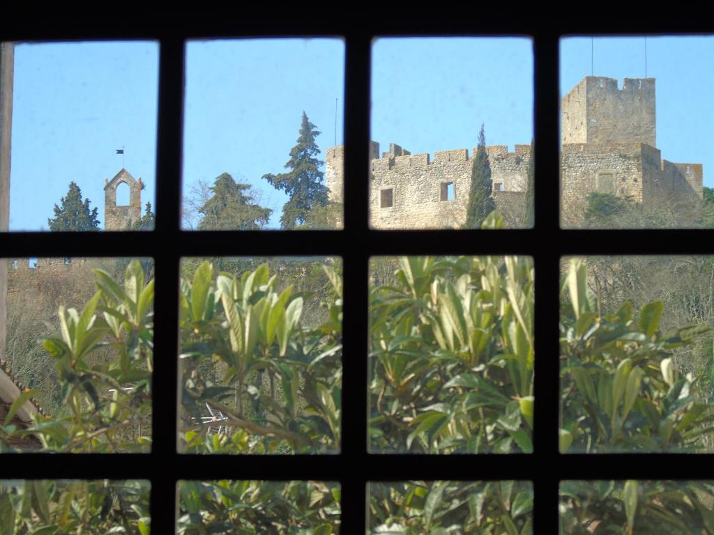 a view of a castle from a window at União - Guest House in Tomar