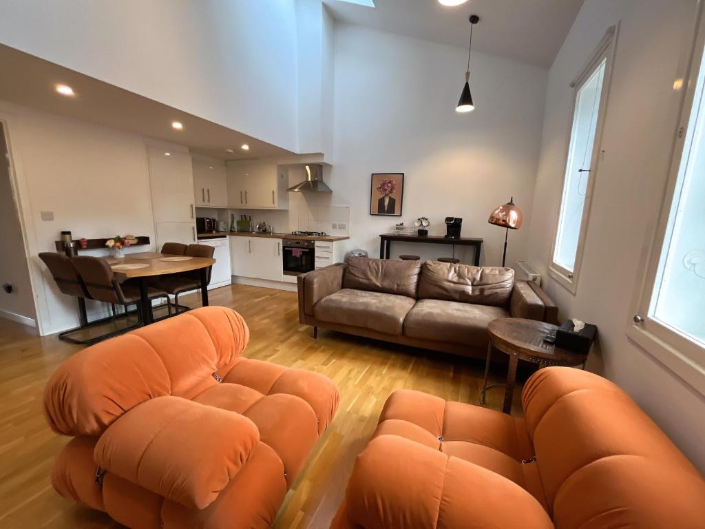 a living room with a couch and a table at 2 Bed 2 bath with Private Parking in Edinburgh