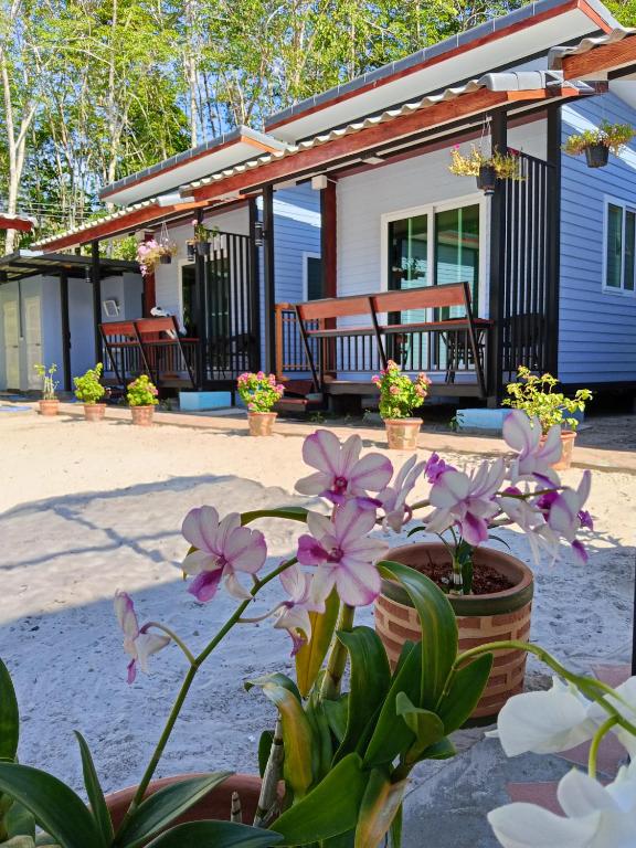 a house with potted flowers in front of it at Mook Raya Resort in Ko Mook