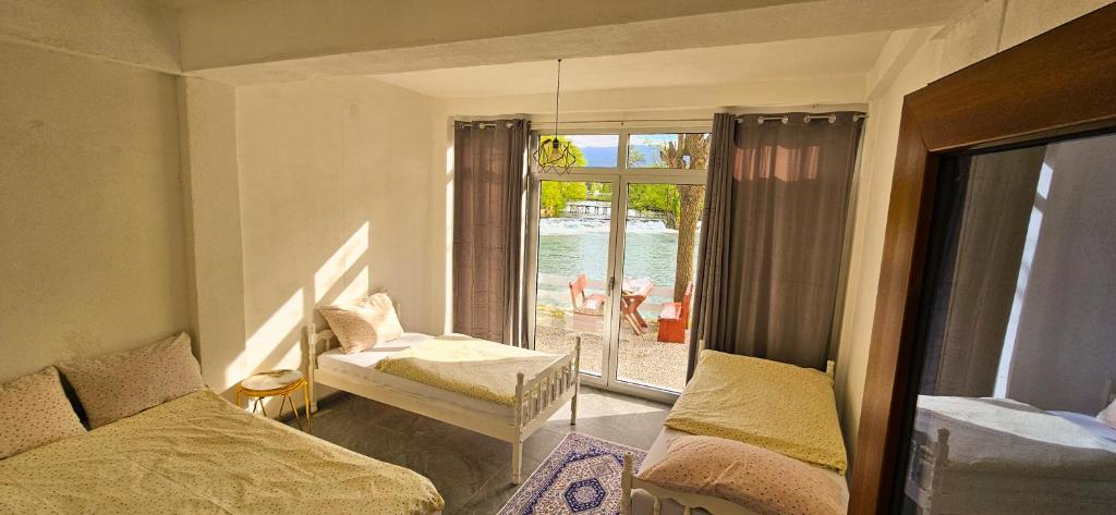 a room with two beds and a window with a view at Apartment Bijela ladja in Bihać