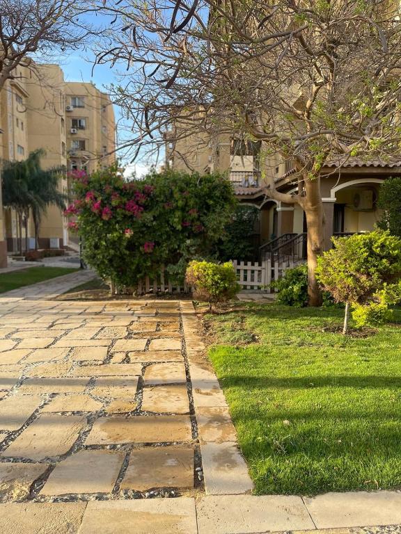 a stone walkway in front of a house at Adam Madinaty hotel in Madinaty