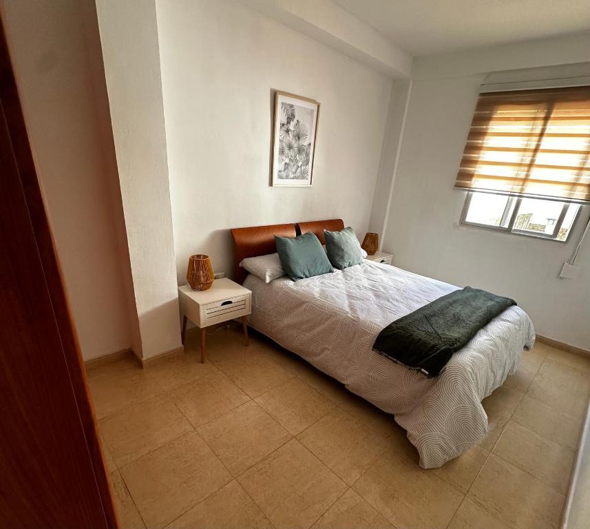 a bedroom with a large bed and a window at Esparta Home ! in Córdoba