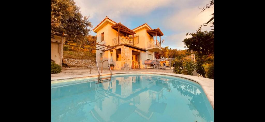 a house and a swimming pool in front of a house at Hikers Villa Trail 5 & 6 in Skiathos Town