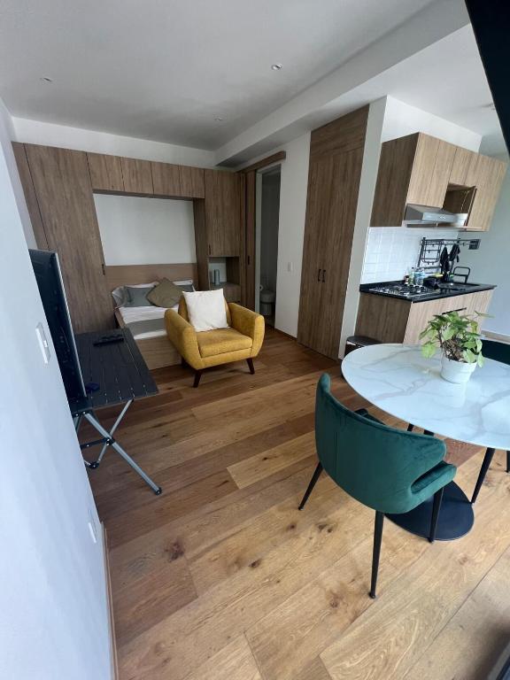 a living room with a table and a couch at Comfortable apartment in Reforma, downtown CDMX in Mexico City