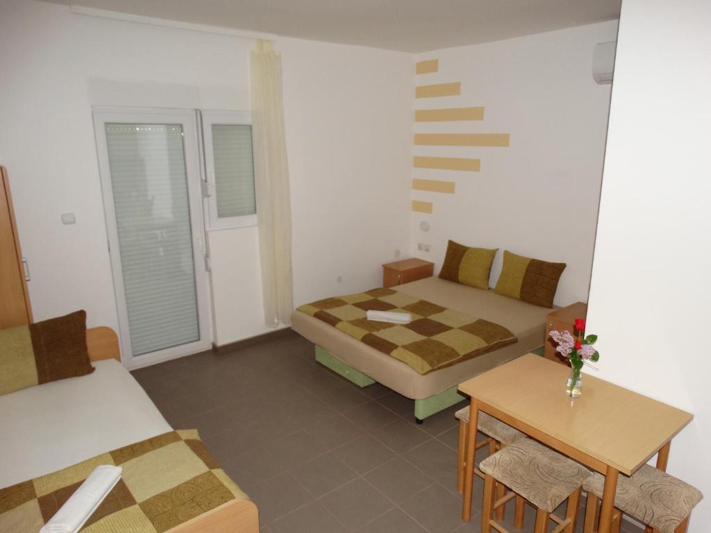 a room with a bed and a couch and a table at Vila Jenic in Soko Banja
